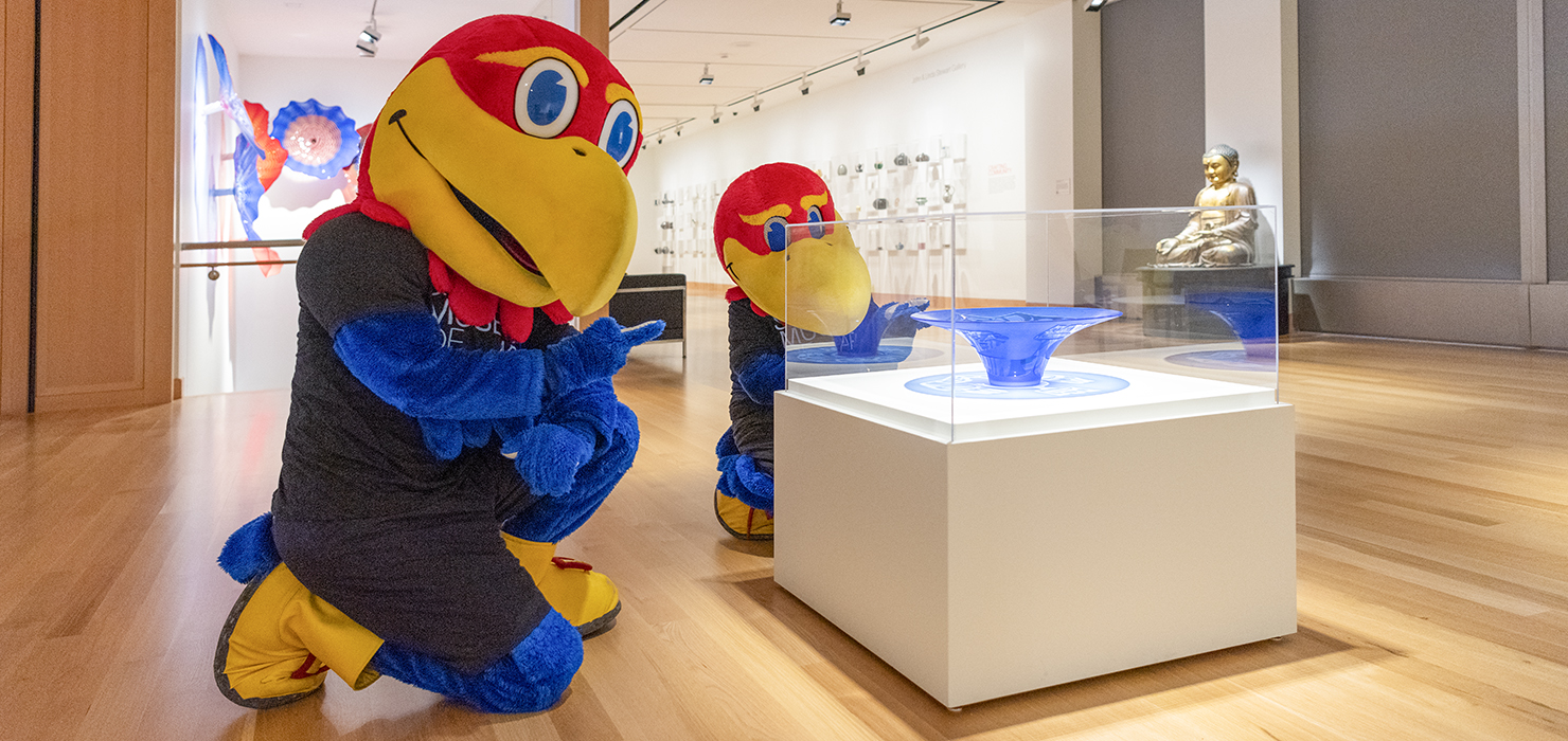 Big Jay and Baby Jay look at a blue glass sculpture in a museum gallery