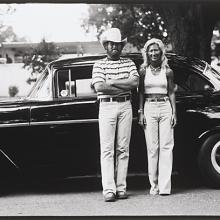 <a href="https://spencerartapps.ku.edu/collection-search#/object/54867" target="_blank"><i>untitled (couple in front of a car)</i> by Thaddeus Holownia</a>