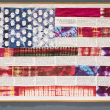 <a href="https://spencerartapps.ku.edu/collection-search#/object/17289" target="_blank"><i>Flag Story Quilt</i> by Faith Ringgold</a>
