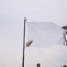 <i>If you'd like to see this flag in colors, burn it (in memory of Marinus Boezem)</i> by  Ahmet Ögüt, photo by Guillaume Ziccarelli, courtesy of Creative Time