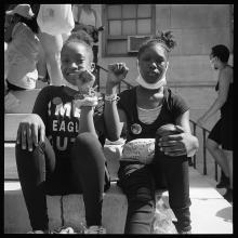 <a href='https://spencerartapps.ku.edu/collection-search#/object/62970' target='_blank'><i>Two sisters on the steps of Brooklyn Borough Hall at George Floyd rally</i> by Accra Shepp</a>
