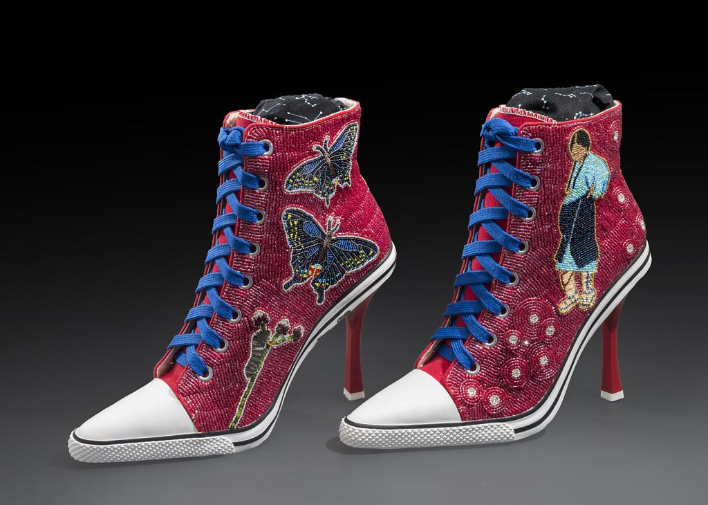 High-heeled Converse sneakers covered in red beadwork with two butterflies and a pregnant Indigenous woman
