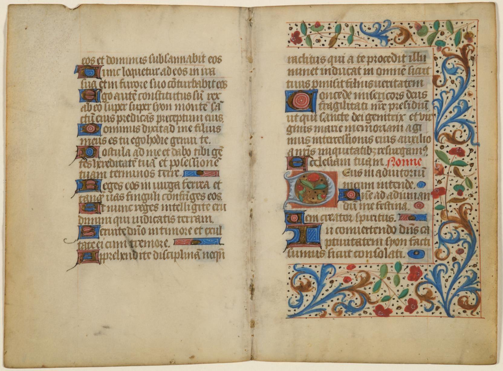 An open book with cream-colored pages and handwritten text decorated with bright flourishes of color