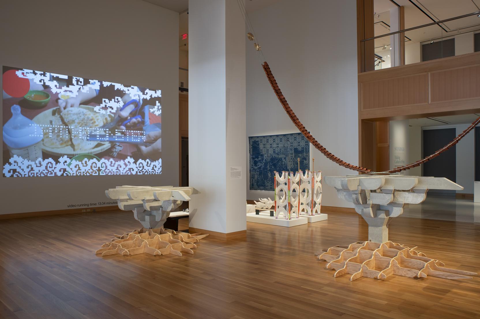 A museum gallery with wood floors and white walls
