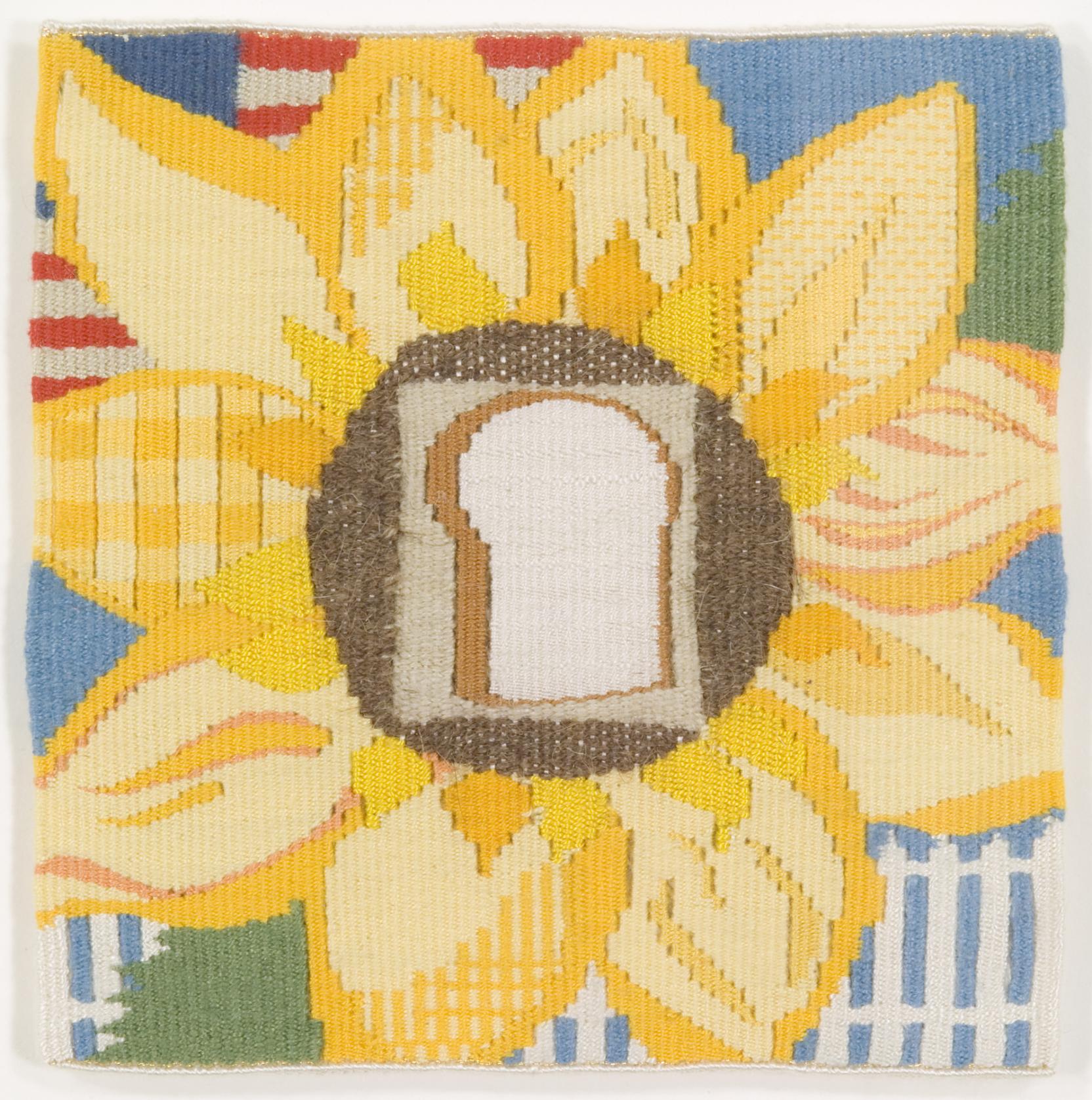 Weaving of sunflower with a slice of white bread in its center and a white picket fence and American flag in the background