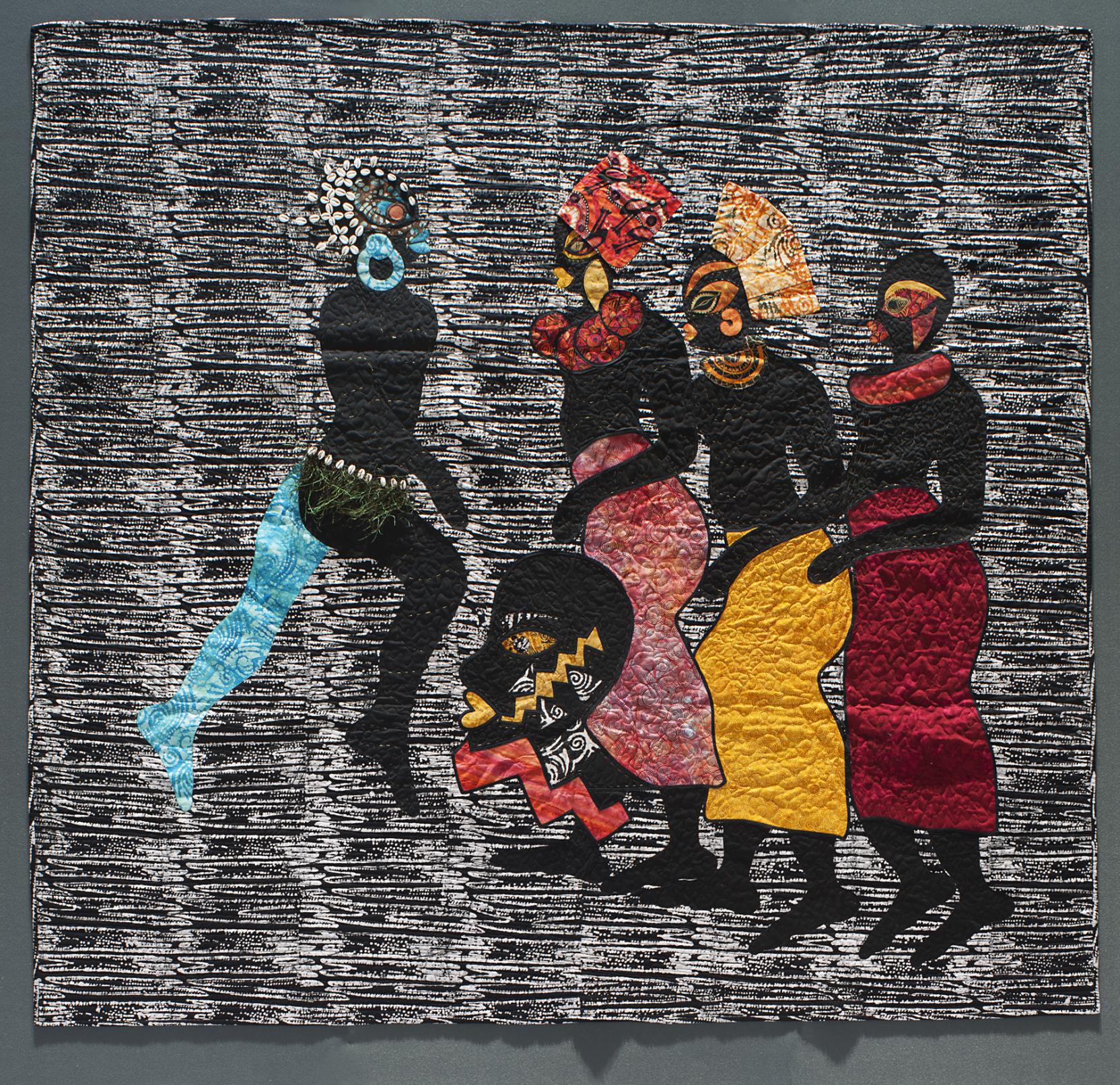 Four black figures wearing colorful skirts and headdresses appear in the center of a black-and-white textile