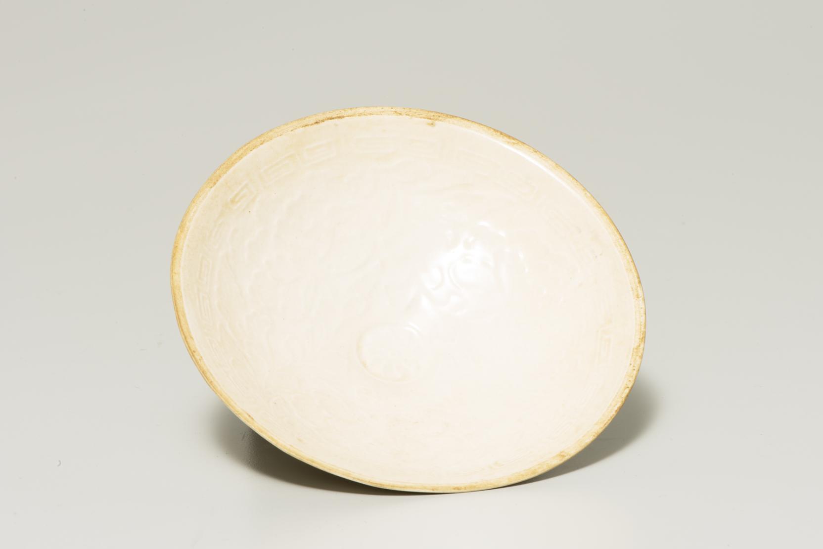 cream-colored bowl with dusty brown-orange rim