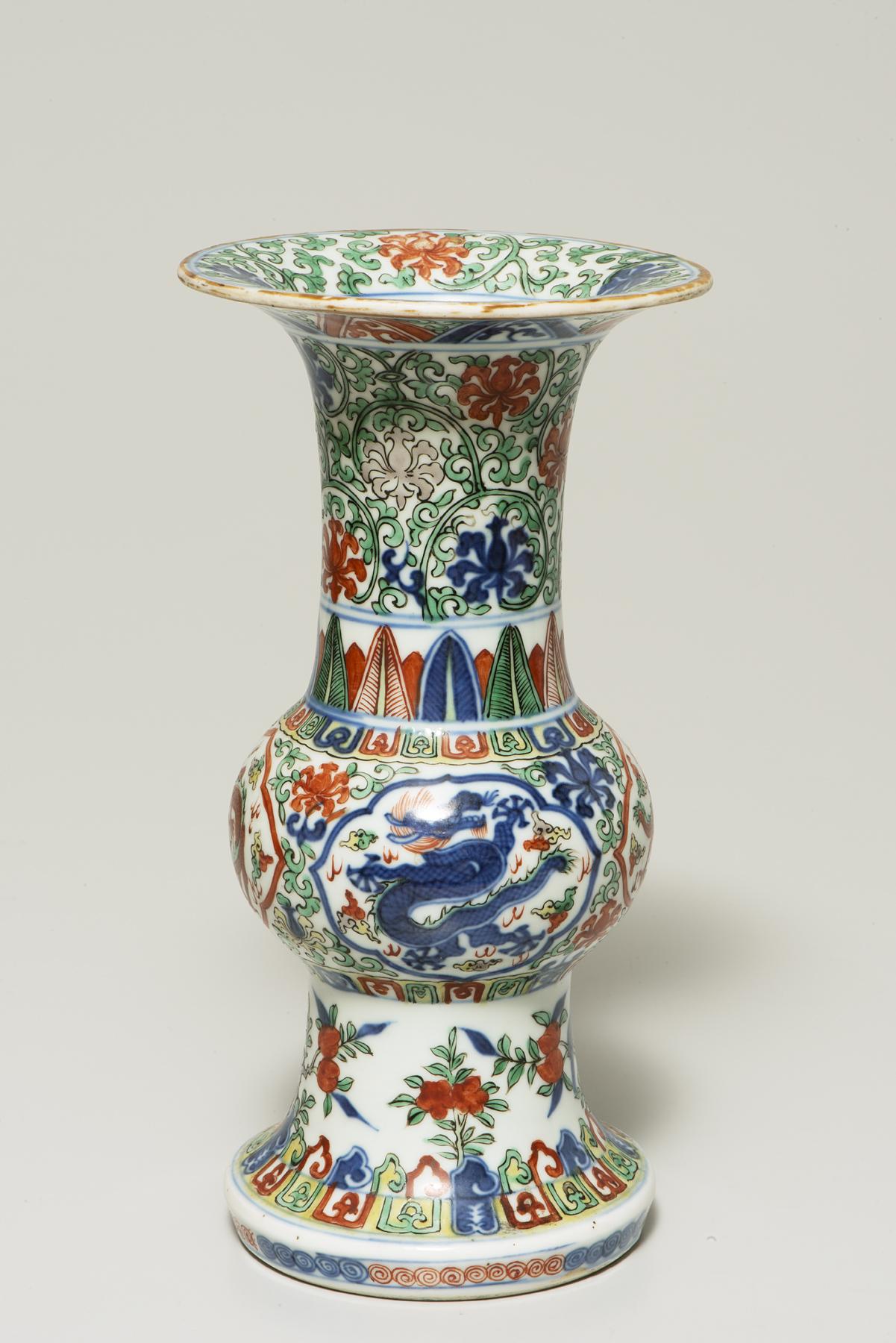 tall white vase with a round section in the middle and a wide rim, decorated with red and blue flowers and a blue dragon at center